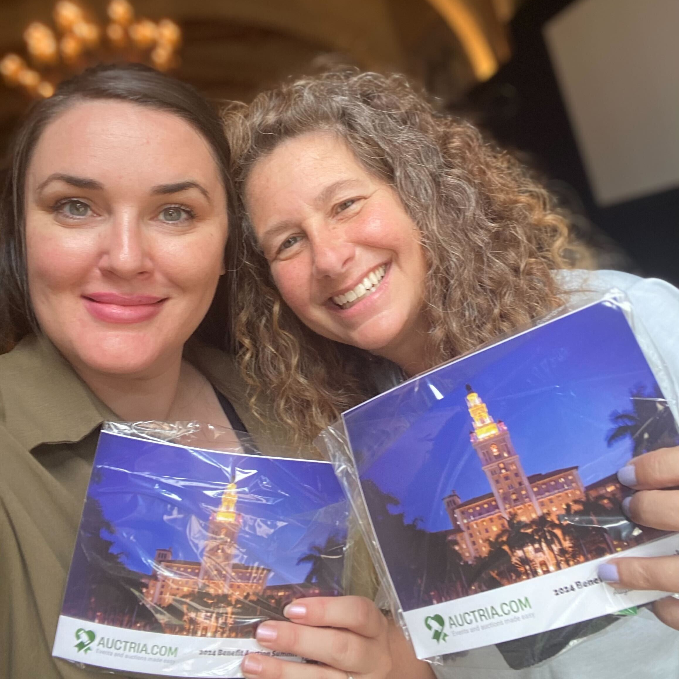 Auctra staff holding photo