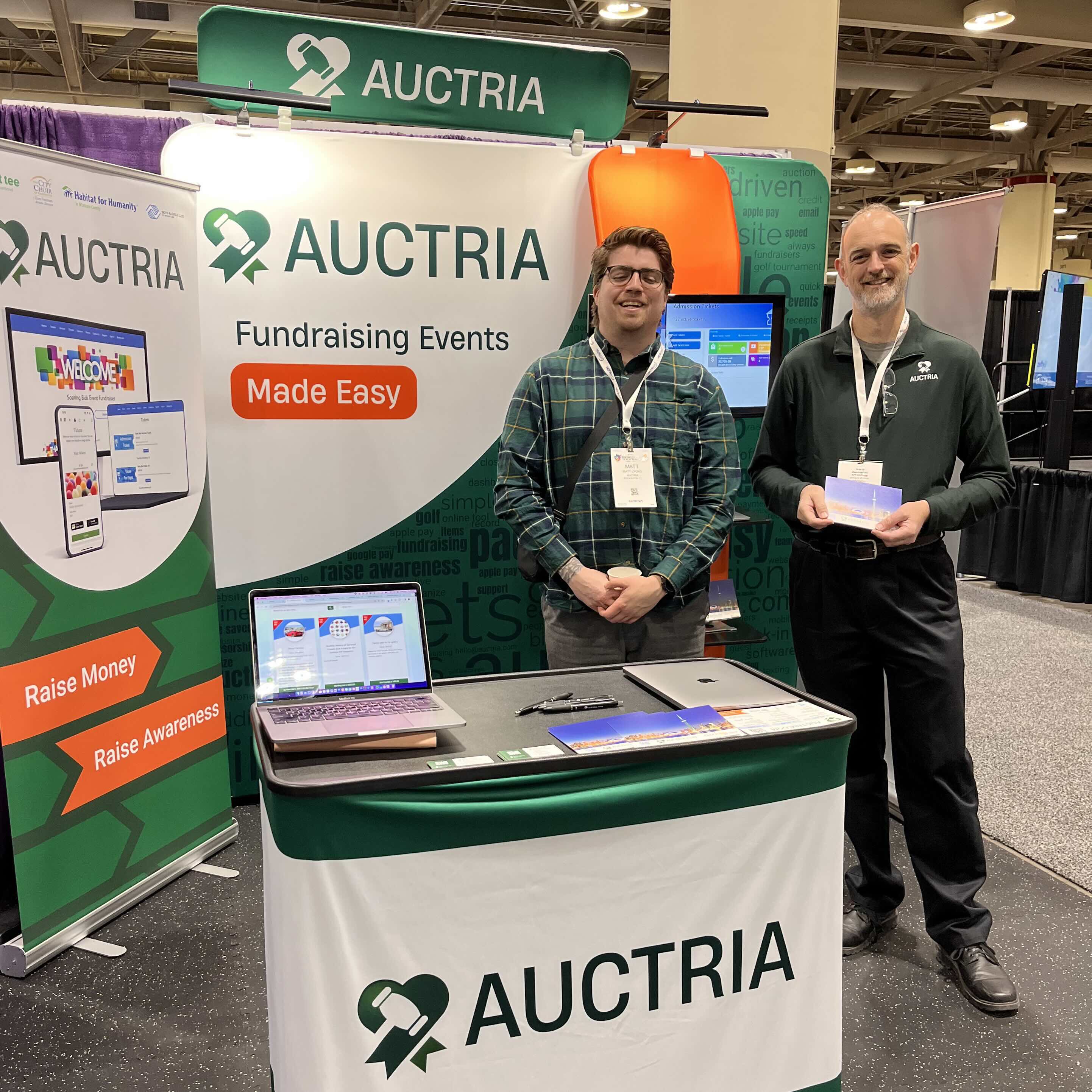 Auctria Staff in front of booth